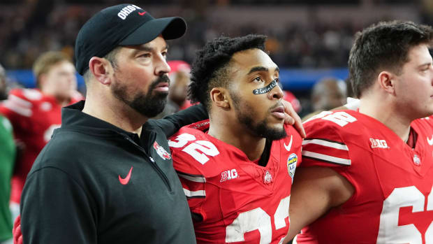 Ohio State Buckeyes head coach Ryan Day and running back TreVeyon Henderson (32) sing Carmen Ohio following their 14-3 loss to the Missouri Tigers in the Goodyear Cotton Bowl Classic at AT&T Stadium.