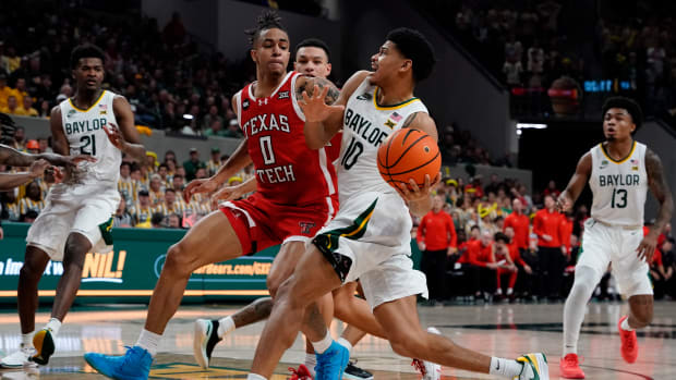 Feb 6, 2024; Waco, Texas, USA; Baylor Bears guard RayJ Dennis (10) drives on Texas Tech Red Raiders guard Chance McMillian (0) during the second half at Paul and Alejandra Foster Pavilion. 