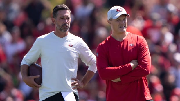 49ers coach Kyle Shanahan, left, and GM John Lynch stand together on the practice field