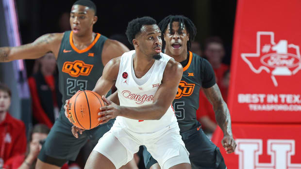 Feb 6, 2024; Houston, Texas, USA; Houston Cougars guard L.J. Cryer (4) controls the ball as Oklahoma State Cowboys guard Quion Williams (5) defends during the first half at Fertitta Center. Mandatory Credit: Troy Taormina-USA TODAY Sports
