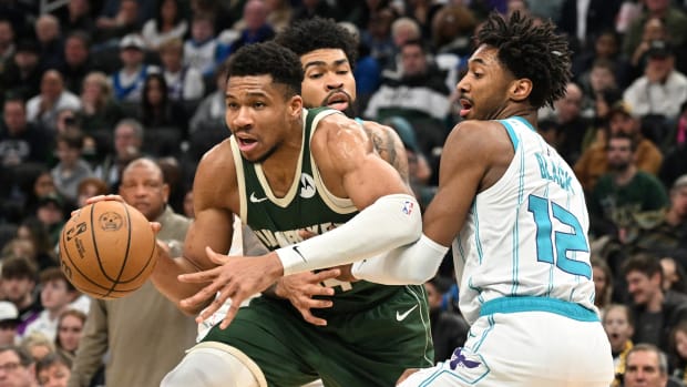Milwaukee Bucks forward Giannis Antetokounmpo (34) attempts to drive against Charlotte Hornets forward Leaky Black (12) in the second half at Fiserv Forum.