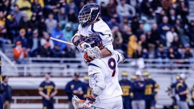 McCabe Millon and Connor Shellenberger celebrate after scoring a goal during the Virginia men's lacrosse game against Michigan at Klockner Stadium.