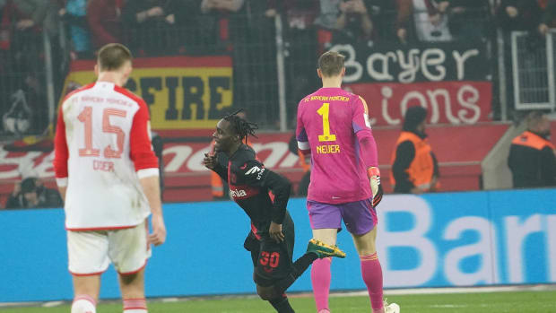 Jeremie Frimpong pictured (center) running past Manuel Neuer (right) after scoring a sensational last-minute goal to seal a 3-0 win for Bayer Leverkusen against Bayern Munich in the Bundesliga in February 2024