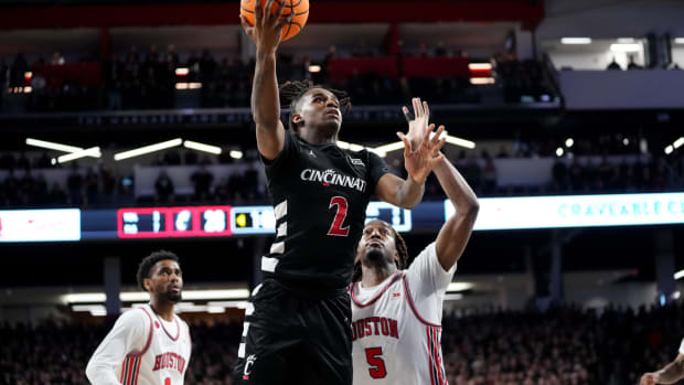 Cincinnati Bearcats guard Jizzle James (2) rises to the basket in the first half of an NCAA college basketball game between the Houston Cougars and the Cincinnati Bearcats, Saturday, Feb. 10, 2024, at Fifth Third Arena in Cincinnati.  