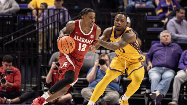 Feb 10, 2024; Baton Rouge, Louisiana, USA; Alabama Crimson Tide guard Latrell Wrightsell Jr. (12) dribbles the ball against LSU Tigers guard Trae Hannibal (0) during the first half at Pete Maravich Assembly Center. Mandatory Credit: Stephen Lew-USA TODAY Sports  