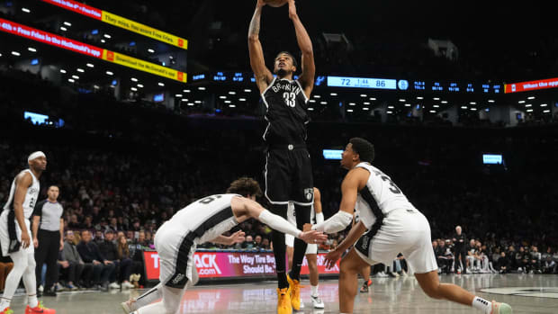 Brooklyn Nets center Nic Claxton (33) shoots a layup against San Antonio Spurs small forward Cedi Osman (16) and San Antonio Spurs small forward Keldon Johnson (3) during the second half at Barclays Center.