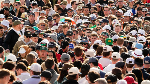 Spectators pack the walkway on the 10th hole during the third round of the WM Phoenix Open at TPC Scottsdale.