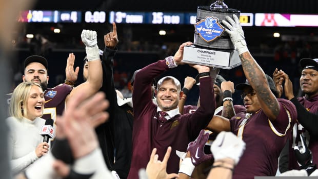 Dec 26, 2023; Detroit, MI, USA; Minnesota Golden Gophers running back Darius Taylor (1) and head coach P.J. Fleck hold up the Quick Lane Bowl trophy after defeating the Bowling Green Falcons at Ford Field.