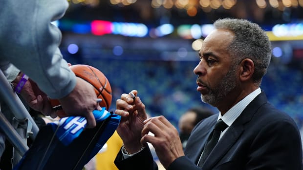 Dell Curry signs autographs before the Hornets' 142-120 win over the Pelicans on March 11, 2022.