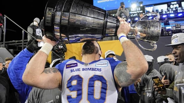 Dec 12, 2021; Hamilton, Ontario, CAN; Winnipeg Blue Bombers defensive tackle Casey Sayles (90) kisses the Grey Cup after defeating the Hamilton Tiger-Cats in the 108th Grey Cup football game at Tim Hortons Field. Mandatory Credit: John E. Sokolowski-USA TODAY Sports  