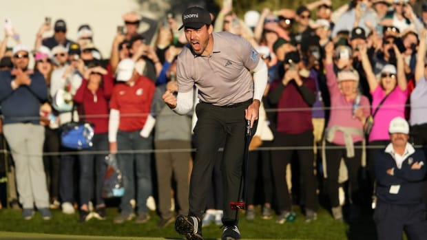 Former UW golfer Nick Taylor drops a birdie putt on the second playoff hole to win the Phoenix Open.