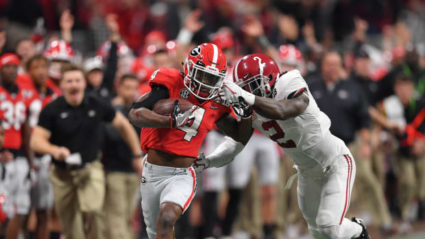 Jan 8, 2018; Atlanta, GA, USA; Georgia Bulldogs wide receiver Mecole Hardman (4) runs for a touchdown after a completion against Alabama Crimson Tide defensive back Tony Brown (2) during the third quarter in the 2018 CFP national championship college football game at Mercedes-Benz Stadium.