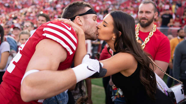 Kyle Juszczyk kisses wife Kristin Juszczyk before the game against the New Orleans Saints at Levi's Stadium.