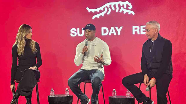 Tiger Woods announces his new Sun Day Red brand on Monday, Feb. 12, with host Erin Andrews and TaylorMade CEO David Abeles.