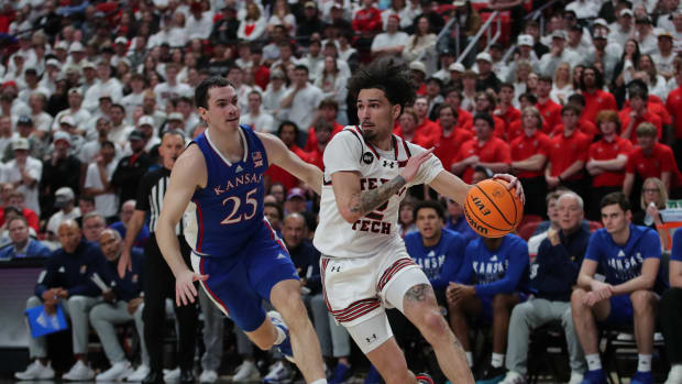 Feb 12, 2024; Lubbock, Texas, USA; Texas Tech Red Raiders guard Pop Isaacs (2) drives to the lane against Kansas Jayhawks guard Nicolas Timberlake (25) in the first half at United Supermarkets Arena. Mandatory Credit: Michael C. Johnson-USA TODAY Sports  