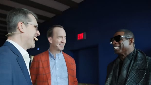 Deion Sanders talking with Peyton Manning and Jim Harbaugh at Super Bowl 58