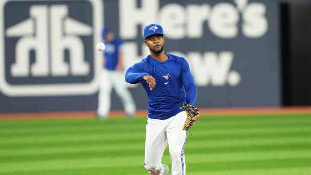 Toronto Blue Jays shortstop Otto Lopez throws a ball to first base during batting practice against the Chicago White Sox at Rogers Centre. (2023)