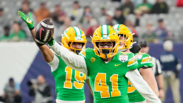 Oregon Ducks defensive back Zach Grisham (41) reacts after recovering a fumble by the Liberty Flames in the second half during the Fiesta Bowl at State Farm Stadium in Glendale on Jan. 1, 2024.