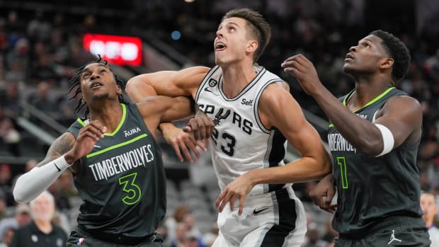 San Antonio Spurs forward Zach Collins (23) battles for position with Minnesota Timberwolves forwards Jaden McDaniels (3) and Anthony Edwards (1) at the AT&T Center in San Antonio on Oct. 30, 2022.