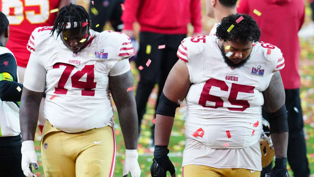 49ers offensive linemen Spencer Burford and Aaron Banks leave the field after losing Super Bowl LVIII.