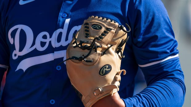 Feb 11, 2024; Glendale, AZ, USA; A general view of a glove and jersey belonging to a Los Angeles Dodgers pitcher Camelback Ranch during Spring Training Workouts.