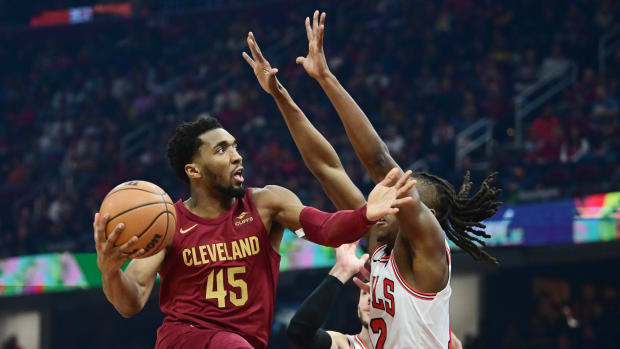 Feb 14, 2024; Cleveland, Ohio, USA; Cleveland Cavaliers guard Donovan Mitchell (45) drives to the basket against Chicago Bulls guard Ayo Dosunmu (12) during the first half at Rocket Mortgage FieldHouse.