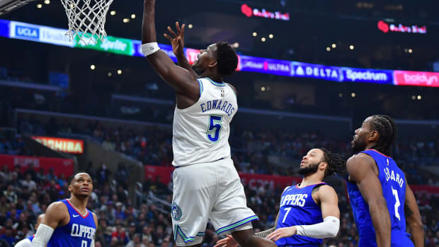 Feb 12, 2024; Los Angeles, California, USA; Minnesota Timberwolves guard Anthony Edwards (5) shoots ahead of Los Angeles Clippers guard Amir Coffey (7) and forward Kawhi Leonard (2) during the first half at Crypto.com Arena.