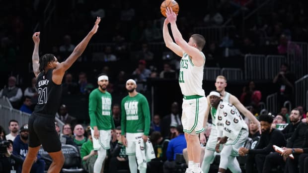 Feb 14, 2024; Boston, Massachusetts, USA; Boston Celtics guard Payton Pritchard (11) shoots for three points against Brooklyn Nets forward Noah Clowney (21) in the second half at TD Garden.