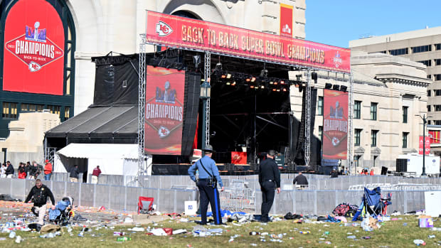 Police officers survey the area near the stage at the end of the Chiefs' Super Bowl parade.
