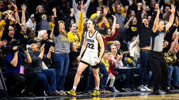 Iowa Hawkeyes guard Caitlin Clark exults after breaking the NCAA women’s basketball scoring record against the Michigan Wolverines on Feb. 15, 2024, in Iowa City.