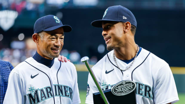 Mar 30, 2023; Seattle, Washington, USA; Seattle Mariners center fielder Julio Rodriguez, right, talks with former player Ichiro Suzuki, left, after receiving his Silver Slugger and Rookie of the Year awards before a game against the Cleveland Guardians at T-Mobile Park.