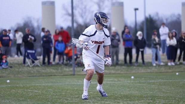 Connor Shellenberger dodges with the ball during the Virginia men's lacrosse game against Michigan at Klockner Stadium.