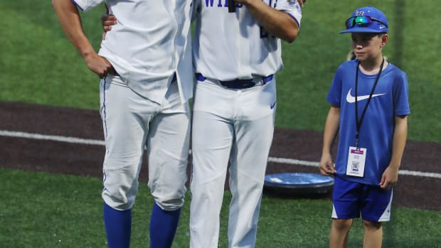 UK head baseball coach Nick Mingione, right, embraced pitcher Darren Williams (5) as he made remarks following their 4-2 victory against Indiana during the NCAA Regional final in Lexington Ky. on June 5, 2023. The win earned UK a spot in the upcoming Super Regional in Louisiana.
