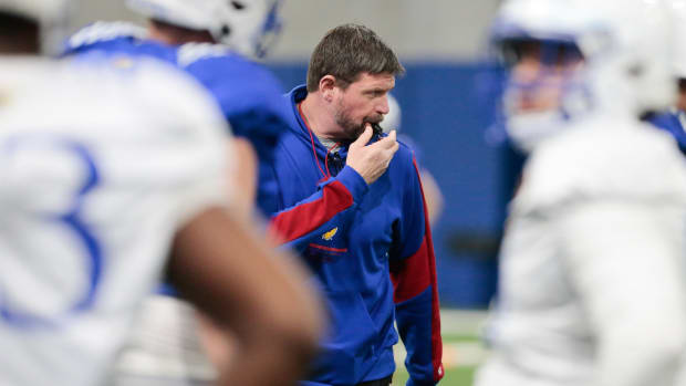 Kansas offensive line coach Scott Fuchs blows his whistle during Tuesday's practice within the Indoor Football Facility.  