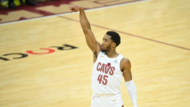 Feb 5, 2024; Cleveland, Ohio, USA; Cleveland Cavaliers guard Donovan Mitchell (45) watches his three-point basket in the third quarter against the Sacramento Kings at Rocket Mortgage FieldHouse.