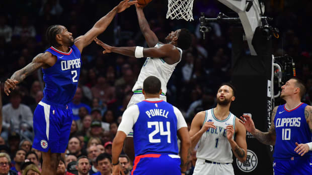 Feb 12, 2024; Los Angeles, California, USA; Minnesota Timberwolves guard Anthony Edwards (5) moves to the basket against the defense of Los Angeles Clippers forward Kawhi Leonard (2) during the second half at Crypto.com Arena.