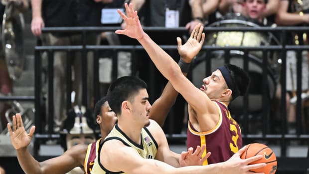 Feb 15, 2024; West Lafayette, Indiana, USA; Purdue Boilermakers center Zach Edey (15) passes the ball around Minnesota Golden Gophers forward Dawson Garcia (3) during the first half at Mackey Arena.