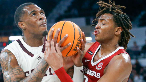 Mississippi State Bulldogs forward Jimmy Bell Jr. (15) and Arkansas Razorbacks forward Chandler Lawson (8) battle for a rebound during the first half at Humphrey Coliseum.