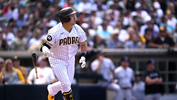 Sep 20, 2023; San Diego, California, USA; San Diego Padres pinch hitter Ji-Man Choi (91) hits a sacrifice fly against the Colorado Rockies during the seventh inning at Petco Park.