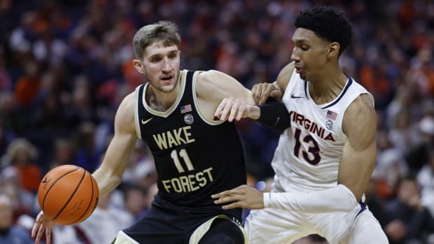 Wake Forest Demon Deacons forward Andrew Carr (11) drives to the basket as Virginia Cavaliers guard Ryan Dunn (13) defends in the first half at John Paul Jones Arena.