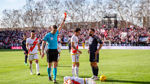 Referee Alejandro Muniz pictured showing a red card to Dani Carvajal (right) after the Real Madrid defender lashed out at Rayo Vallecano midfielder Kike Perez (bottom) during a La Liga game in February 2024