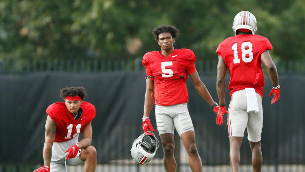 Ohio State Buckeyes wide receiver Marvin Harrison Jr. (18) gets a high five from wide receiver Garrett Wilson (5) after catching a pass during football training camp at the Woody Hayes Athletic Center in Columbus on Tuesday, Aug. 10, 2021. Ohio State Football Training Camp