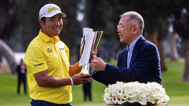Hideki Matsuyama is presented the trophy after winning The Genesis Invitational golf tournament at Riveria Country Club. 