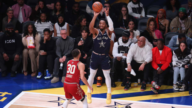 Feb 18, 2024; Indianapolis, Indiana, USA; Eastern Conference guard Donovan Mitchell (45) of the Cleveland Cavaliers attempts a three-point basket against Western Conference guard Stephen Curry (30) of the Golden State Warriors during the fourth quarter in the 73rd NBA All-Star Game at Gainbridge Fieldhouse.