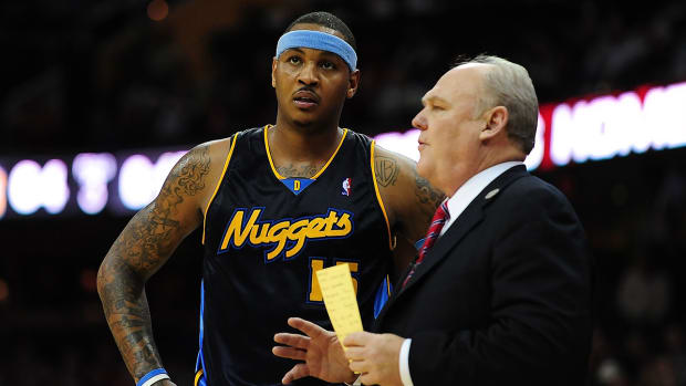 Denver Nuggets forward Carmelo Anthony (15) talks with coach George Karl during the game against the Cleveland Cavaliers at Quicken Loans Arena.