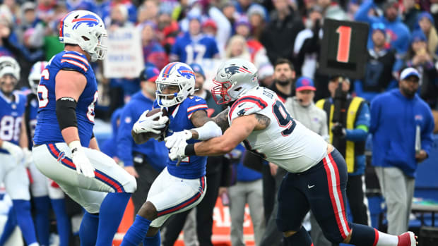 Dec 31, 2023; Orchard Park, New York, USA; Buffalo Bills wide receiver Stefon Diggs (14) is tackled by New England Patriots defensive end Lawrence Guy Sr. (93) after making a catch in the second quarter at Highmark Stadium. Mandatory Credit: Mark Konezny-USA TODAY Sports