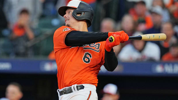 Oct 8, 2023; Baltimore, Maryland, USA; Baltimore Orioles first baseman Ryan Mountcastle (6) hits an RBI sacrifice fly during the fourth inning against the Texas Rangers during game two of the ALDS for the 2023 MLB playoffs at Oriole Park at Camden Yards. Mandatory Credit: Mitch Stringer-USA TODAY Sports