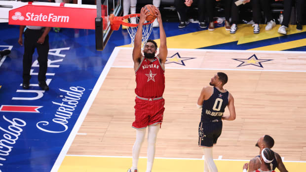 Feb 18, 2024; Indianapolis, Indiana, USA; Western Conference center Karl-Anthony Towns (32) of the Minnesota Timberwolves dunks the ball past Eastern Conference guard Tyrese Halliburton (0) of the Indiana Pacers during the fourth quarter in the 73rd NBA All Star game at Gainbridge Fieldhouse. Mandatory Credit: Trevor Ruszkowski-USA TODAY Sports