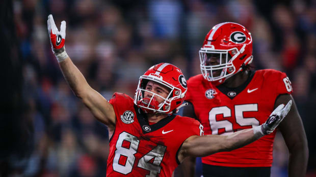 Nov 11, 2023; Athens, Georgia, USA; Georgia Bulldogs wide receiver Ladd McConkey (84) celebrates after a touchdown with offensive lineman Amarius Mims (65) against the Mississippi Rebels in the first quarter at Sanford Stadium.