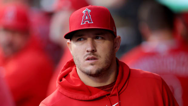 Angels centerfielder Mike Trout stands in the dugout during a game.